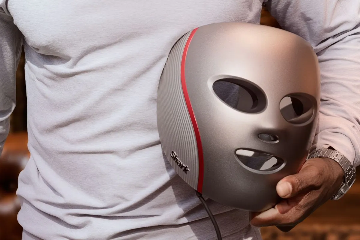 LED mask held by man,